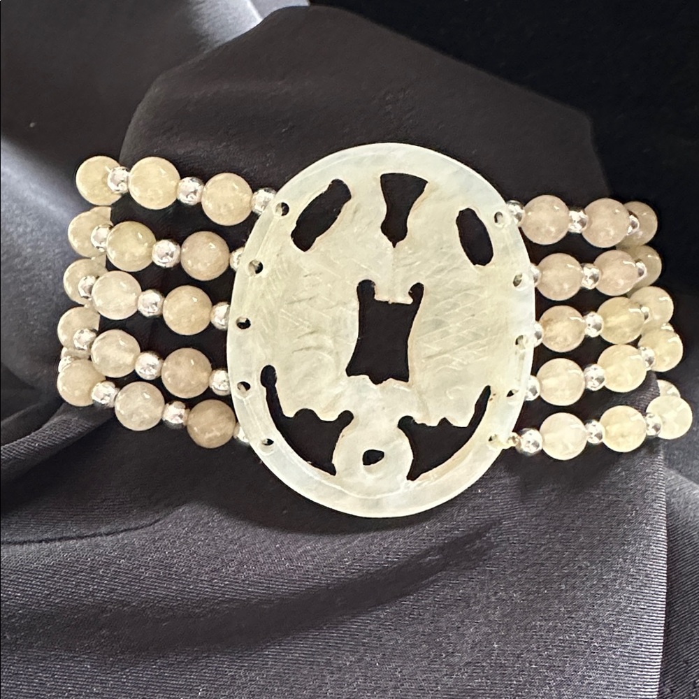 White jade EUC multi-layered bracelet w/ oval carved fish motif pendant.